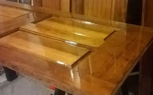 Raised-panel wood door with a fresh high-gloss stain and clear coat